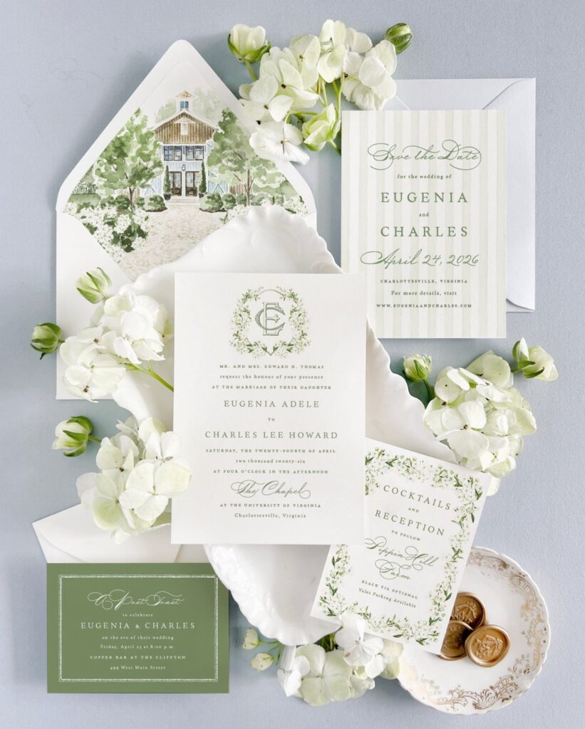 Wedding invitation suite with a watercolor house illustration and white floral accents.